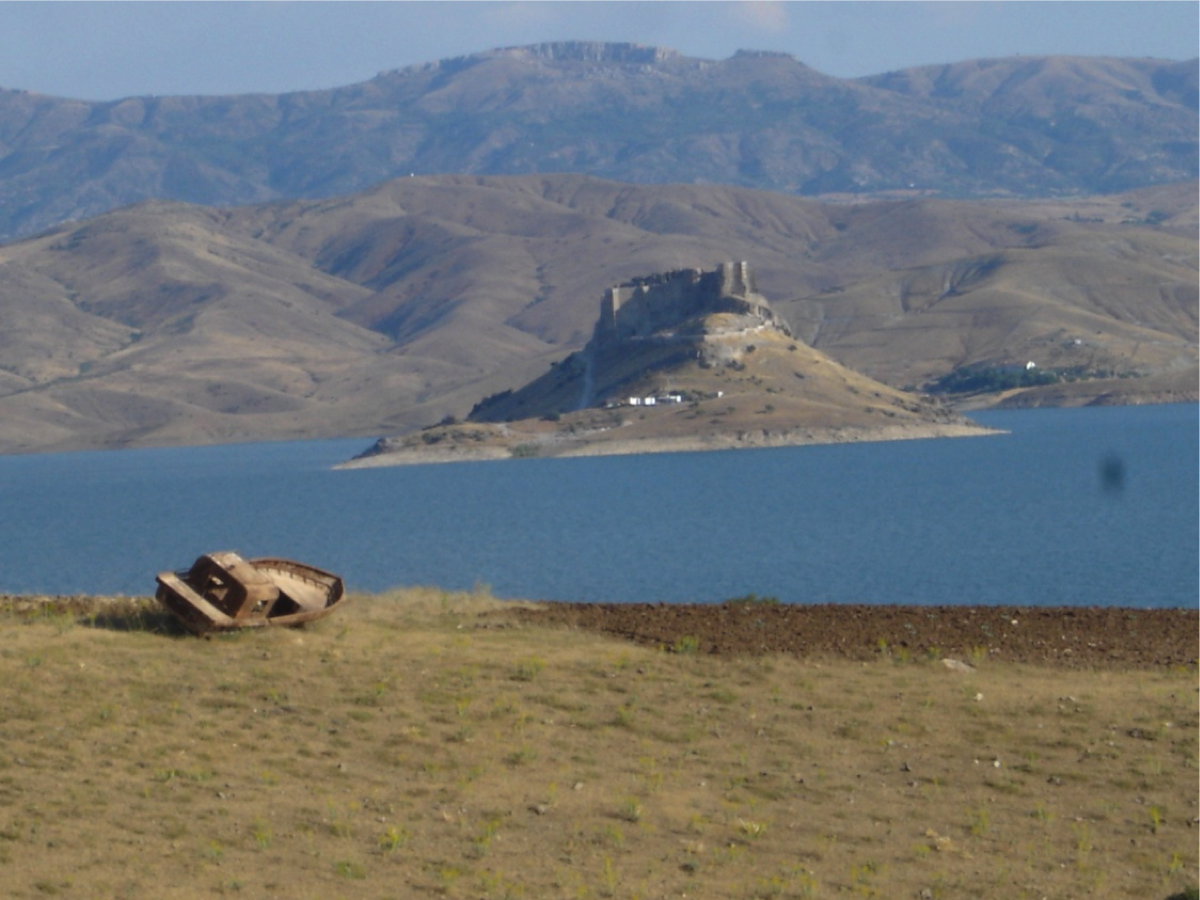 Pertek Castle on an island in the Keban reservoir, viewed from the shore.
