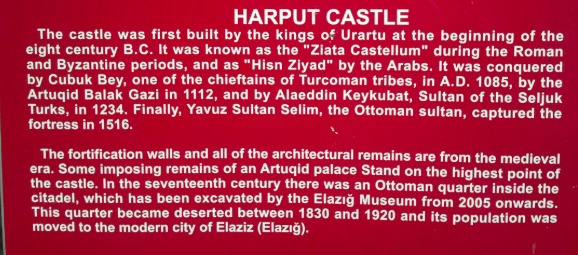 An English-language sign at Harput Castle describing successive conquests and the relocation of an Ottoman quarter to Elazığ.